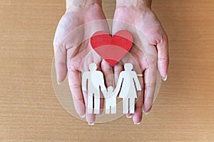 Woman hands holding red heart and icon family, health care, family insurance concept