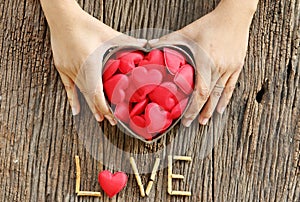 Woman hands holding red heart shaped