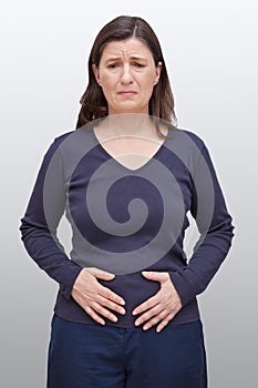 Woman hands holding stomach pain photo