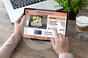Woman hands holding tablet computer with app delivery food
