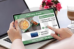 Woman hands holding tablet computer with app delivery food