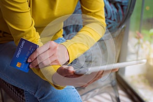 Woman hands holding tablet with credit card for Online shopping