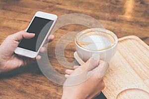 woman hands holding touching mobile phone with blank copy space for your text message in cafe with light Sunset