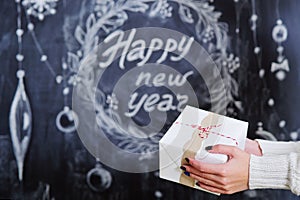 Woman hands holding wrapped gift box