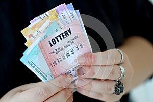 Woman hands with indian rupees bills and lottery ticket. Concept of gambling and winning money in indian lottery