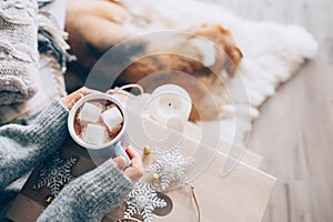 Woman hands ith cup of hot chocolate close up image, cozy home, photo