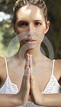 Woman With Hands Joined Meditating Outdoors