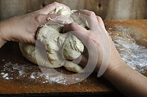 Woman hands kneading dough