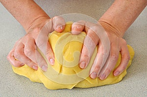 Woman hands kneading dough