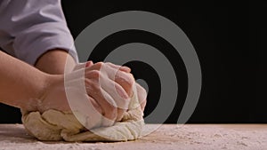 Woman hands kneading dough in flour on the table. Process of making handmade dough from flour. Making bread, cooking