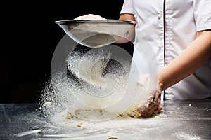 Woman hands kneading dough. powder