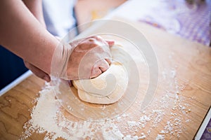 Woman hands kneading pasta dough bread
