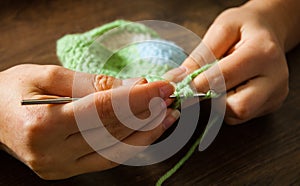 Woman hands knitting with crochet hook