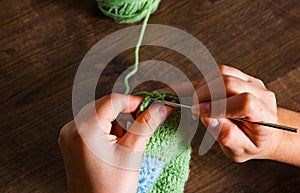 Woman hands knitting with crochet hook