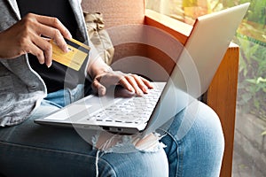Woman hands with laptop and Credit card shopping online. Payment Transaction at Computer using Credit Card