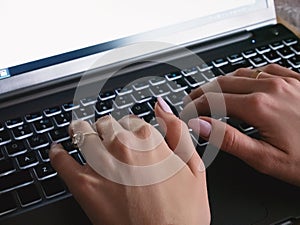 Woman hands on laptop keyboard clsoe up