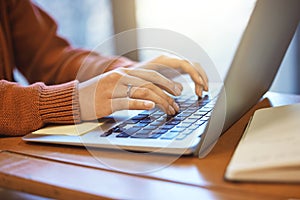 Woman with hands, laptop and student typing, education and writing report or essay, studying for exam at university
