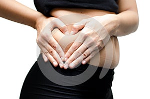 Woman hands make heart shape on belly