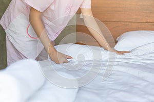 Woman of Hands making bed in the bedroom