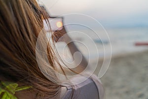 Woman hands making frame gesture distant with sunset on sea beach view, Female capturing sunlight outdoor. Future planning idea