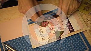 Woman hands making a scrapbooking holiday postcard