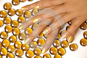 Woman hands manicure with gold nail polish