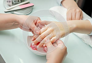 Woman hands in a nail salon receiving a  hand massage by a beautician. SPA manicure