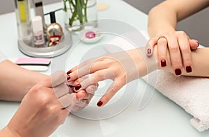 Woman hands in a nail salon receiving a manicure