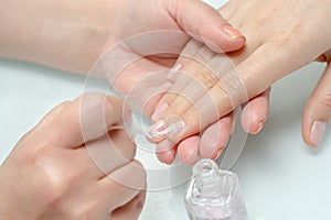 Woman hands in a nail salon receiving a manicure