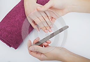 Woman hands in a nail salon receiving a manicure procedure. SPA