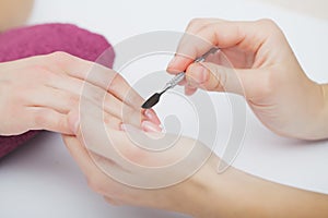 Woman hands in a nail salon receiving a manicure procedure. SPA