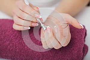 Woman hands in a nail salon receiving a manicure procedure. SPA