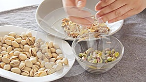 Woman hands opening pistachios