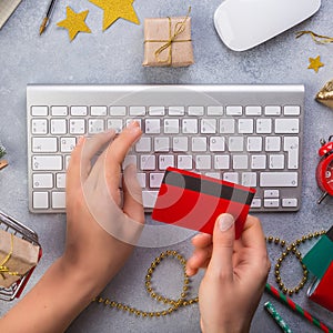 Woman hands paying with credit card. Top view of online christmas gifts online - online shopping