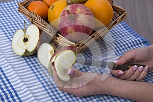 Woman hands peeling an apple