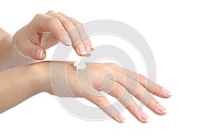 Woman hands with perfect manicure applying moisturizer cream