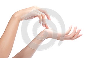 Woman hands with perfect manicure applying moisturizer cream.