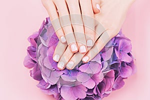 Woman hands with perfect pastel pink manicure.