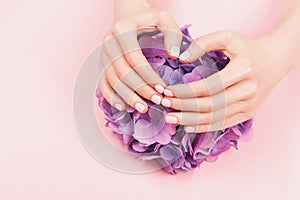 Woman hands with perfect pastel pink manicure.