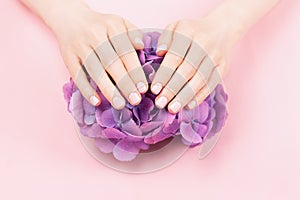 Woman hands with perfect pastel pink manicure.