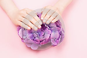 Woman hands with perfect pastel pink manicure.
