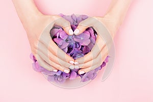 Woman hands with perfect pastel pink manicure.