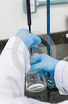 Woman hands performing titration test on chemical quality contro photo