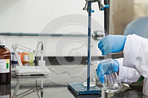 Woman hands performing titration test on chemical quality contro photo