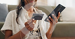 Woman, hands and phone with credit card for online shopping, payment or transaction in living room at home. Closeup of