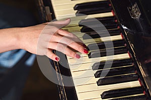 Woman hands on piano keys