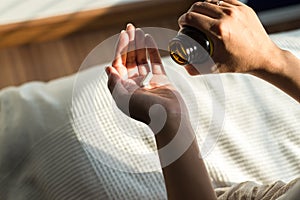 Woman hands with pills on spilling pills out of bottle,Female hand holding a medicine