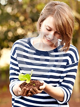 Woman, hands and plant for hope, future or growth in eco farming in sustainability in environment. Female worker, farmer