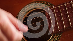 Woman hands playing classical acoustic guitar, closeup. Music concept. Girl learning to play song and writing music