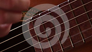 Woman hands playing classical acoustic guitar, closeup. Music concept. Girl learning to play song and writing music